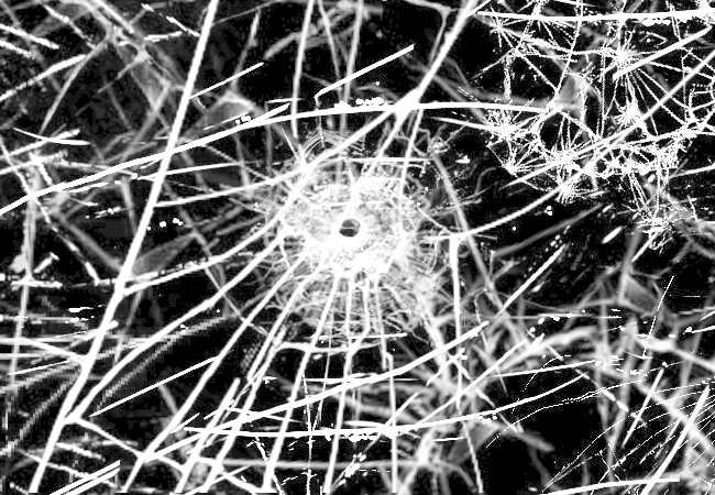The cracks widen again, spreading like a network across the entire screen.