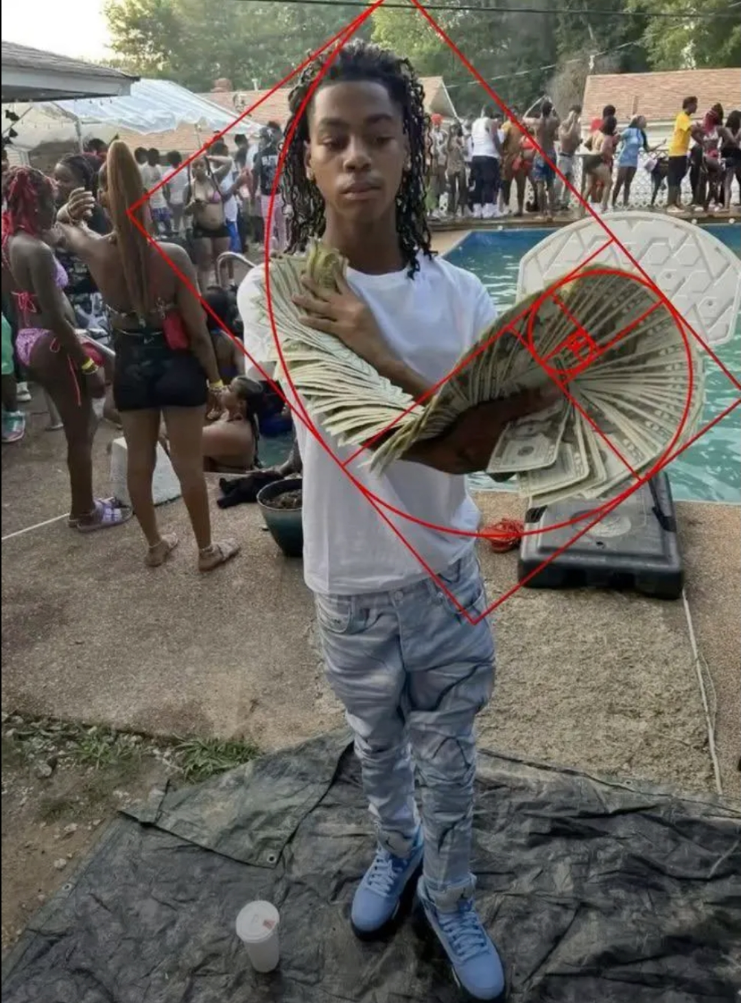 guy holding up money spread that matches the golden ratio at the pool