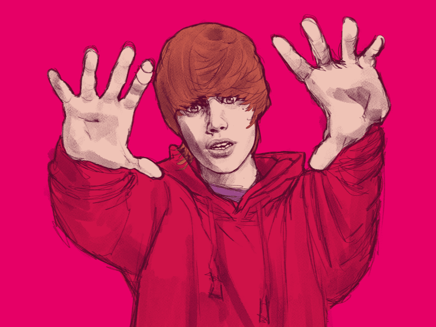 Young Justin Bieber holding his hands out to the viewer, framing his face in a strange manner.