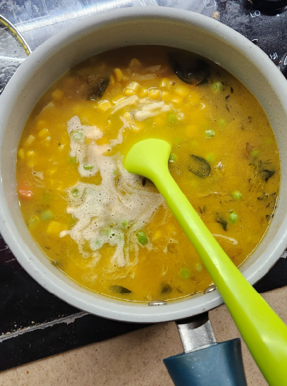 A yellow vegetable soup in a pot.
