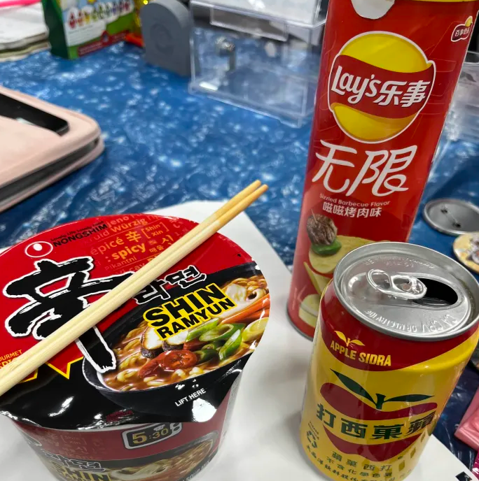 Collection of Asian snacks; Shin Ramyun, Taiwanese barbecue-flavored Pringles, and Taiwanese apple cider