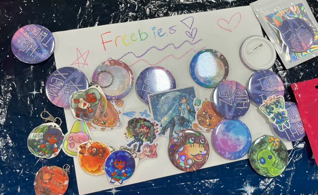 A collection of freebies, consisting of various pins and stickers designed by Wanderstar