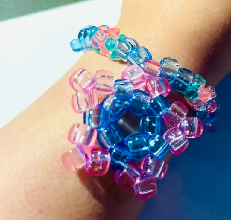 Display of the Kandi bracelet crafted by SWAMP GOD, being worn on Hoshi's wrist.