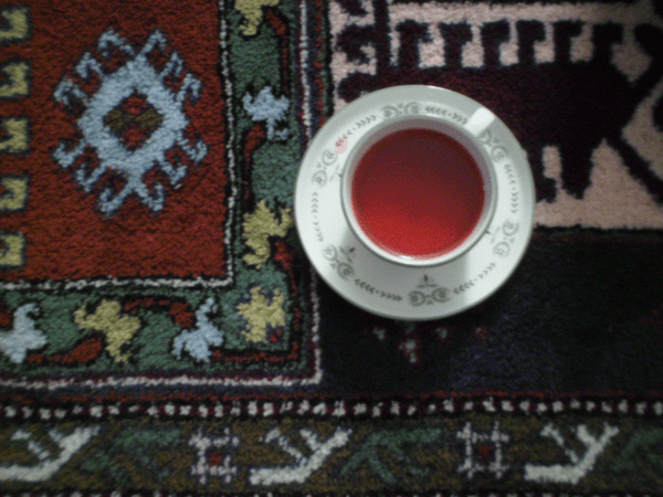 a shot of a teacup on an ornate rug