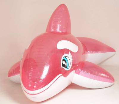 A big pink orca pool toy with blue eyes.