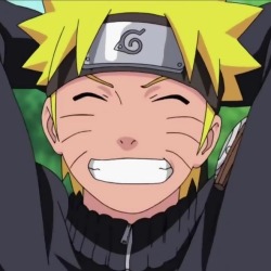 An image of Naruto Uzumaki from Naruto Shippuden. He is grinning widely at the screen.