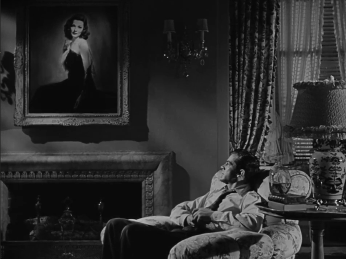 A screencap from Laura, depicting the main detective sitting on an armchair, looking at Laura's portrait.