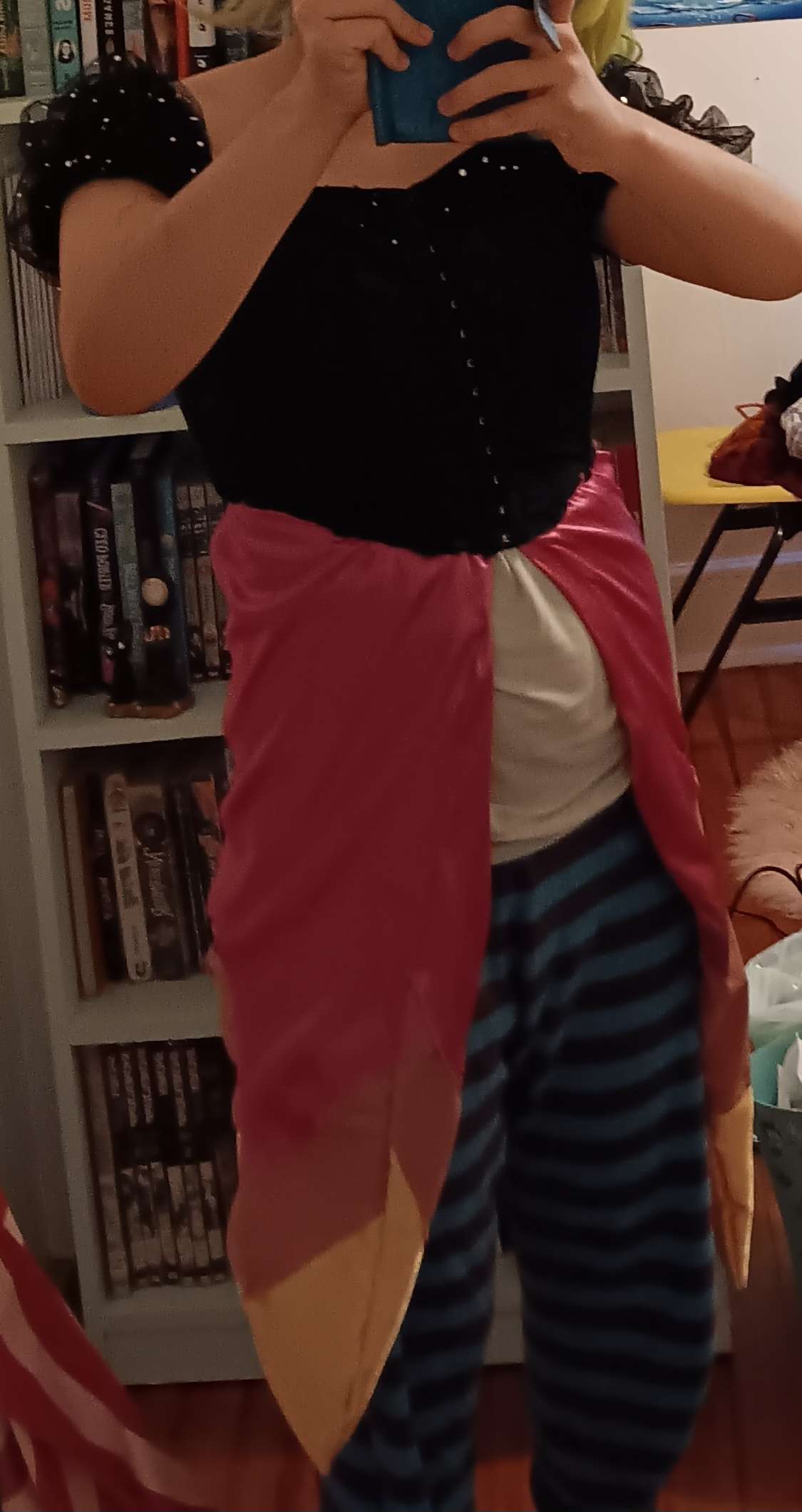 The same dress is pictured. From the front, you can see that the skirt splits down the middle to show the legs.
