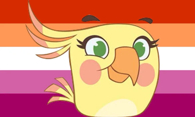 Poppy in front of the lesbian pride flag.