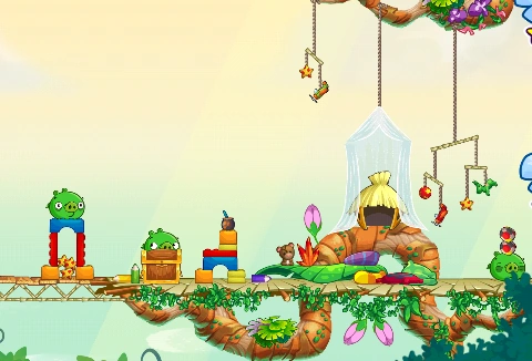 A tiny little hut covered by a thin blue veil. several crib mobiles are hung around it. Several pigs are messing with the toys around it.