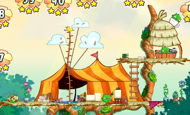 A yellow tent with orange stripes (or an orange tent with yellow stripes) adorned with art supplies, and a ladder leading to the second floor, containing a small cafe. Pigs are messing about, of course.
