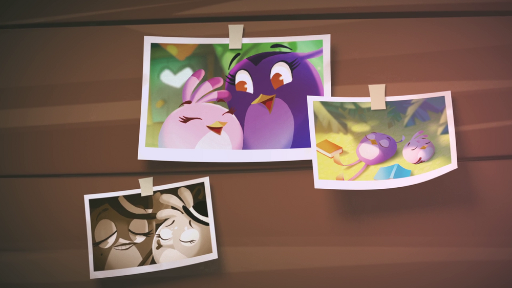 Three photos taped on a wall, all of them depicting a purple bird named Gale, and a pink bird named Stella. The first photo shows both birds inside Stella's treehouse, smiling at each other. The second photo shows both of them lying down on a grass field, books strewn beside them. The third is a sepia-toned photo, with both birds wearing bowler hats. Also lesbian jumpscare.