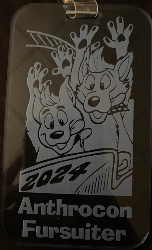 clear pale blue acrylic badge showing a white decal of some furries on a rollercoaster with the text 2024 anthrocon fursuiter