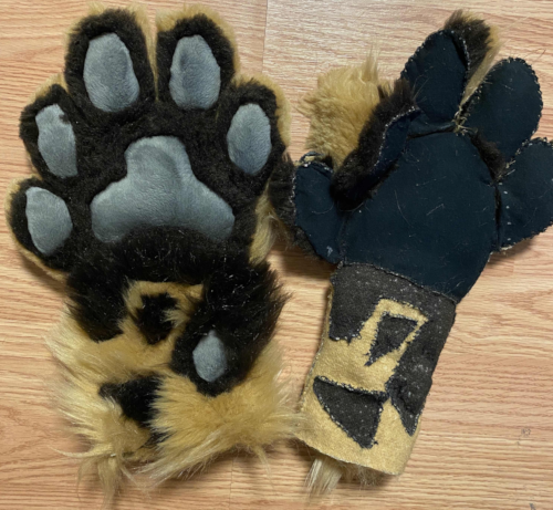 two brown tabby cat fursuit paws. one is right side out, and the other is inside out and still partially unsewn.