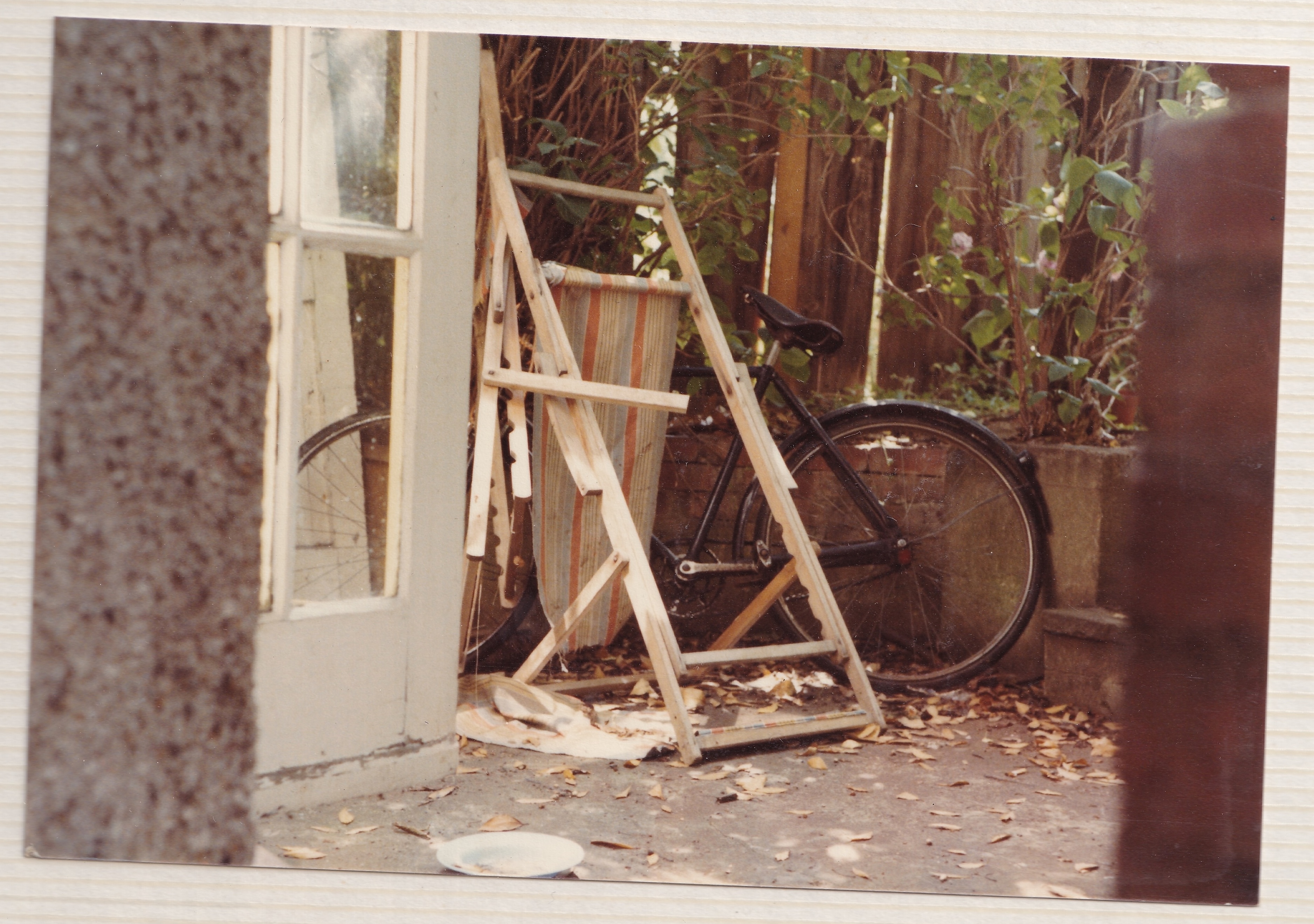 A broken lounge chair and a bike