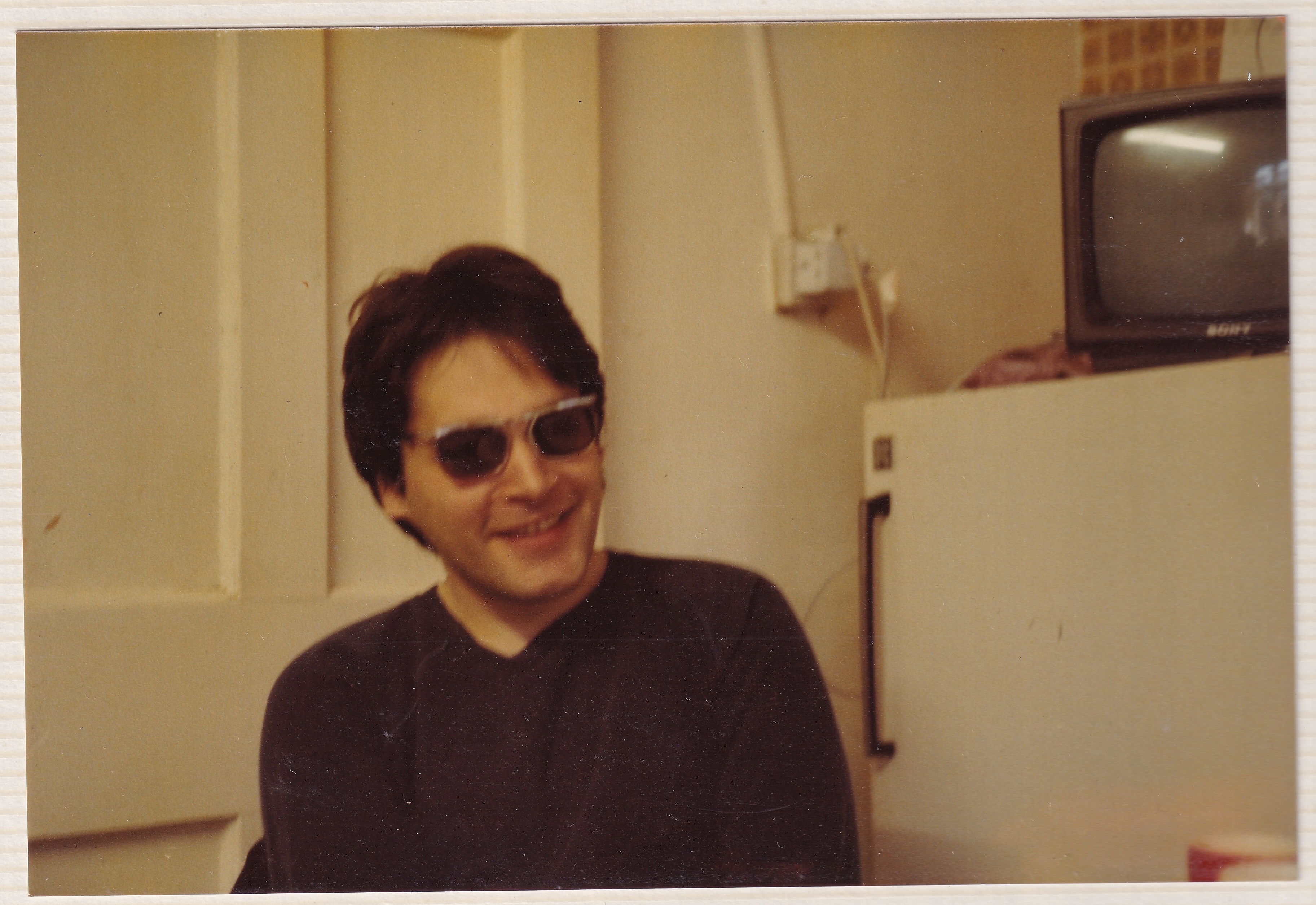 George smiling and wearing sunglasses