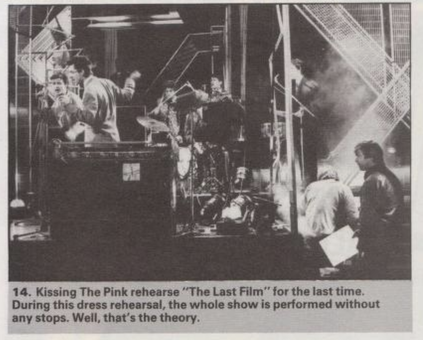 The same stage as above but at a closer angle. This time Nick, Jon, Jo, Stevie and Peter are seen, as view of George is blocked by a camera. Caption is transcribed below