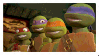 A digital stamp with a gif from the 2012 version of TMNT. The four turtles are sitting lined up, then Mikey yawns and passes out.