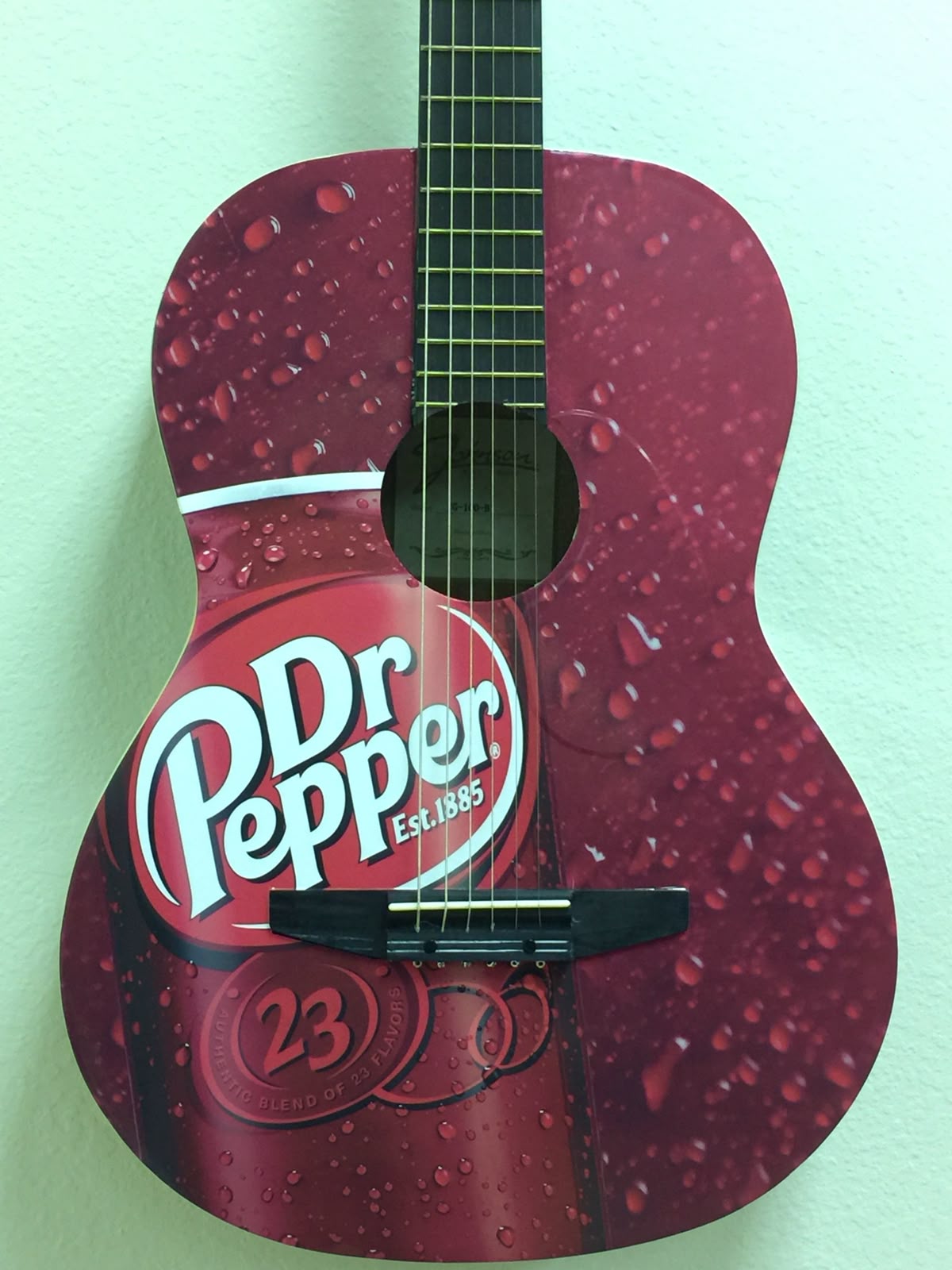 a guitar with the dr. pepper logo on it