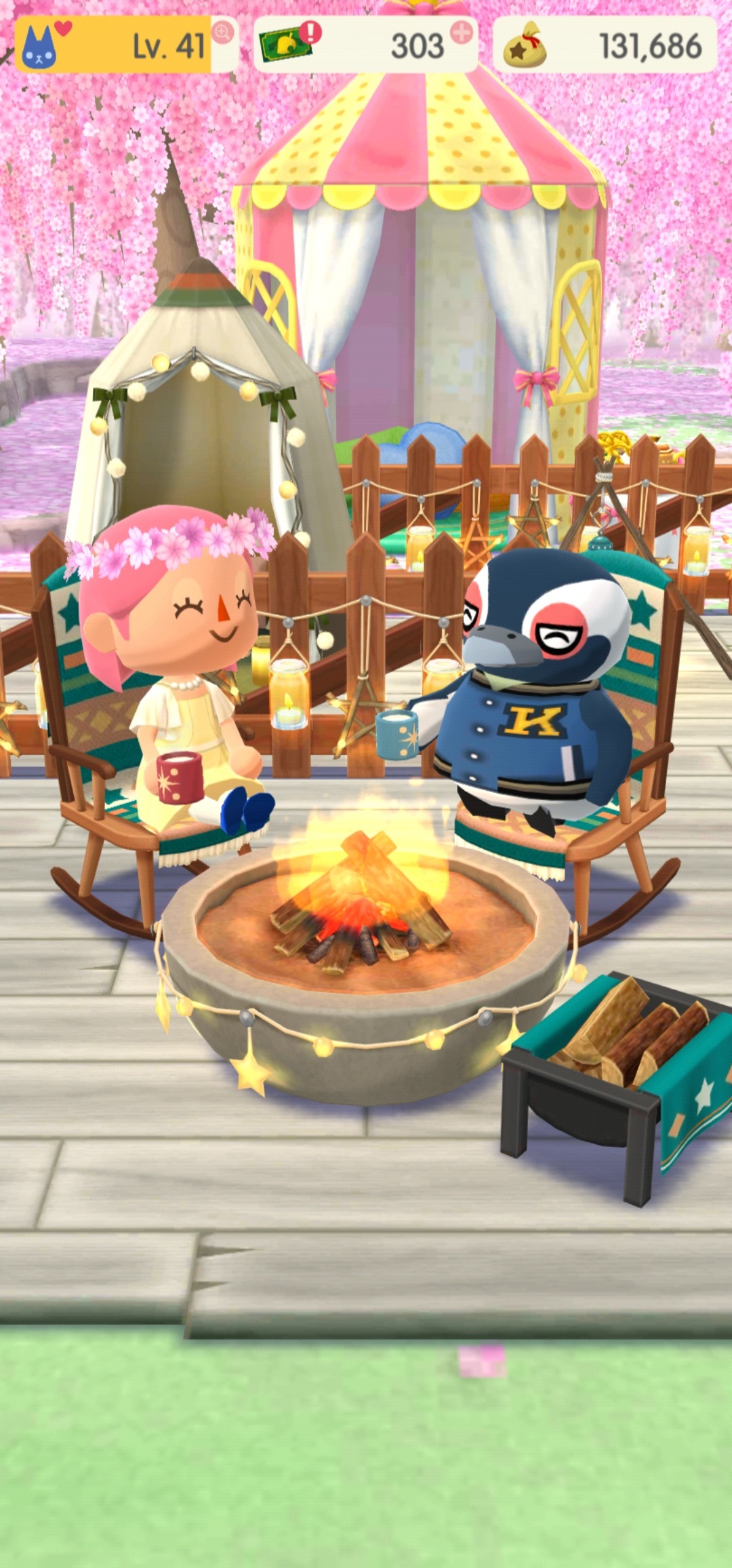 Tex and Vayla sitting on rocking chairs drinking soda in front of a campfire.