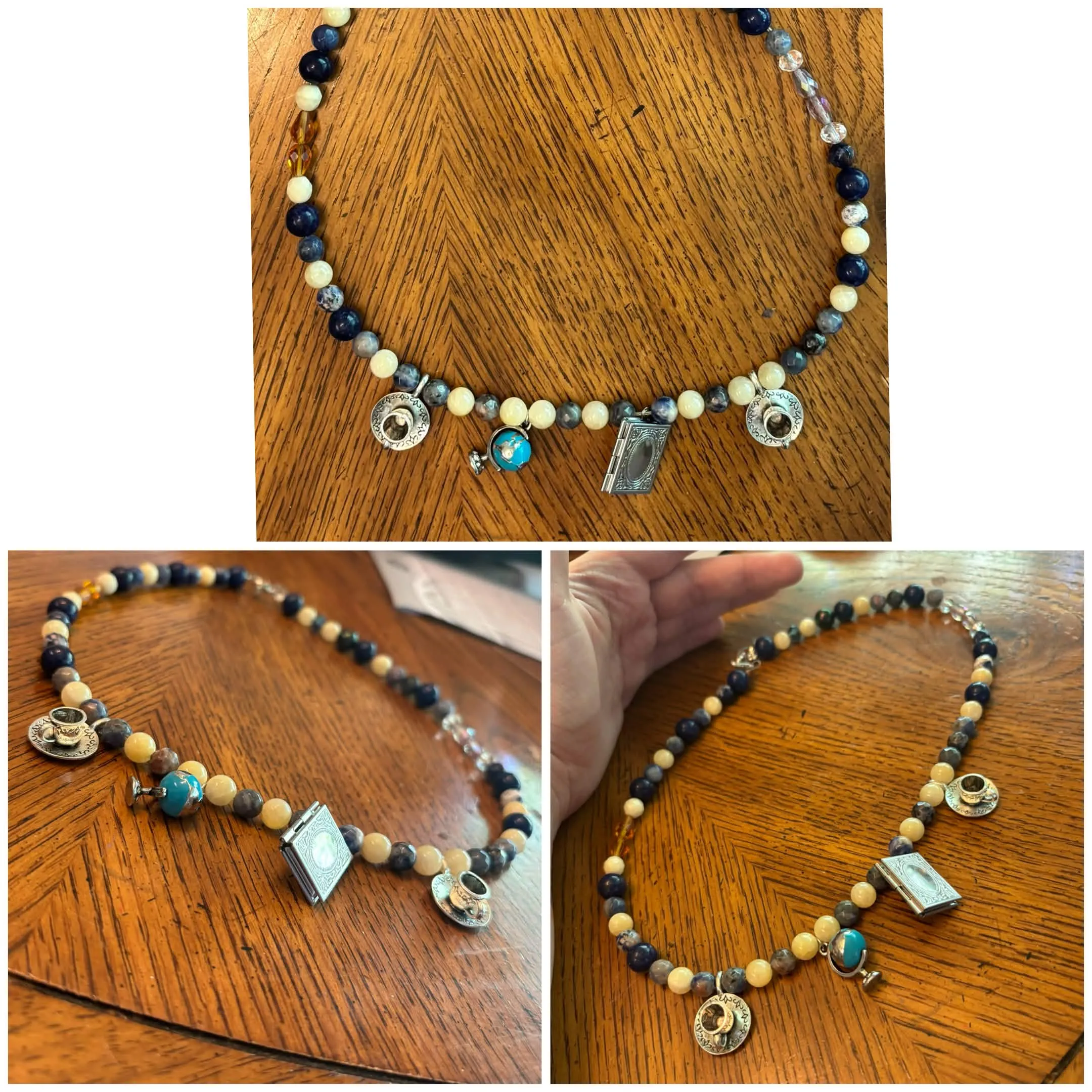 A necklace with yellow/black/navy beads and a book charm, teacup charm, and globe charm