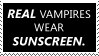 A stamp reading Real vampires wear
					sunscreen.