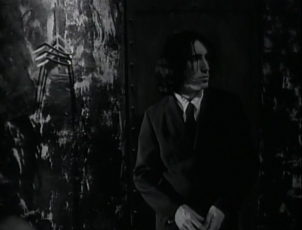 black and white shot of Trent Reznor in a black suit and tie