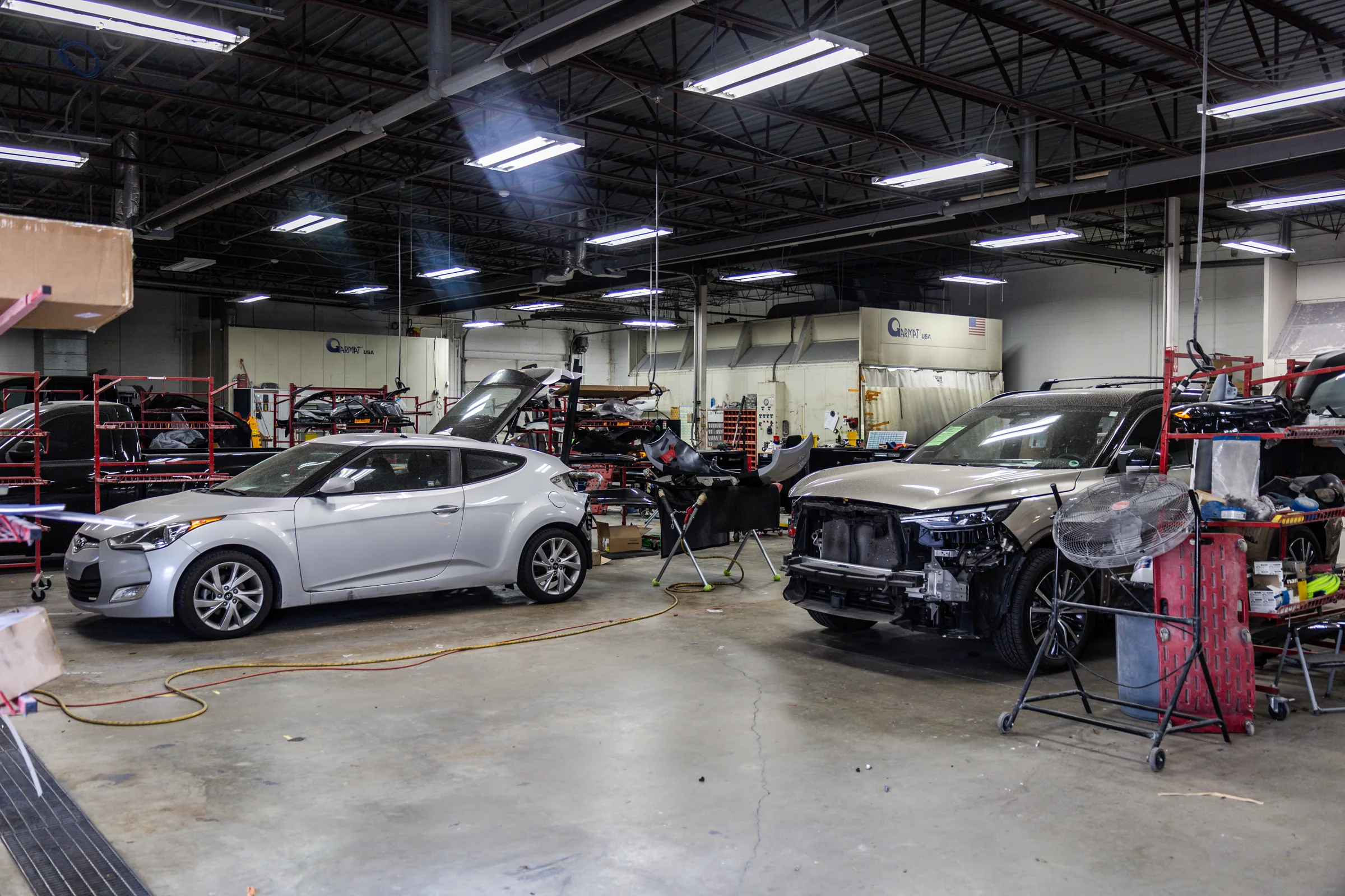 Active collision repair floor at Crash Champions on West Markham Road
