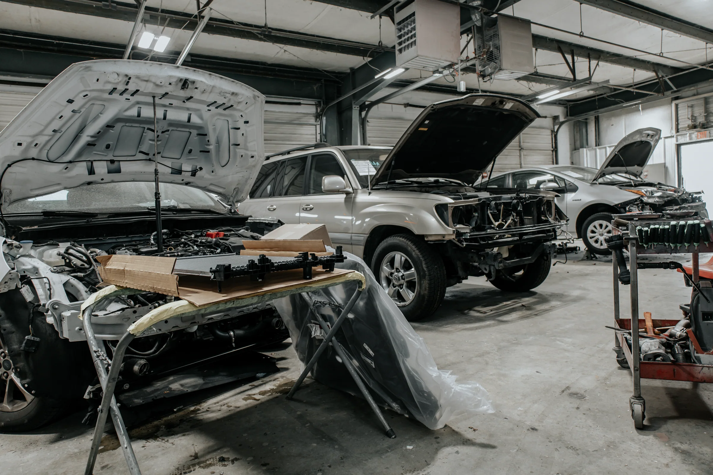 Vehicles undergoing collision repair inside Crash Champions in Sherwood