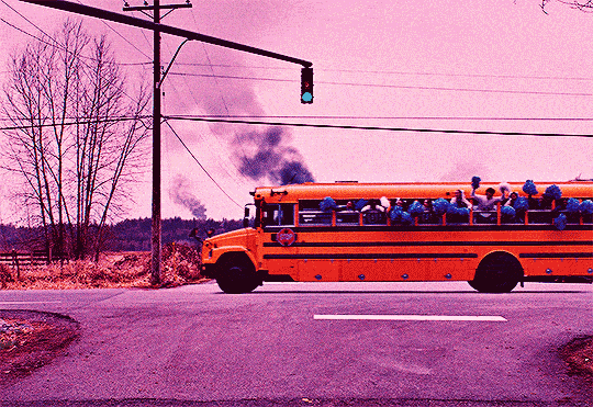 gif from the movie The Monkey showing cheerleaders waving pompoms out of bus windows before a semi-truck drives through their heads