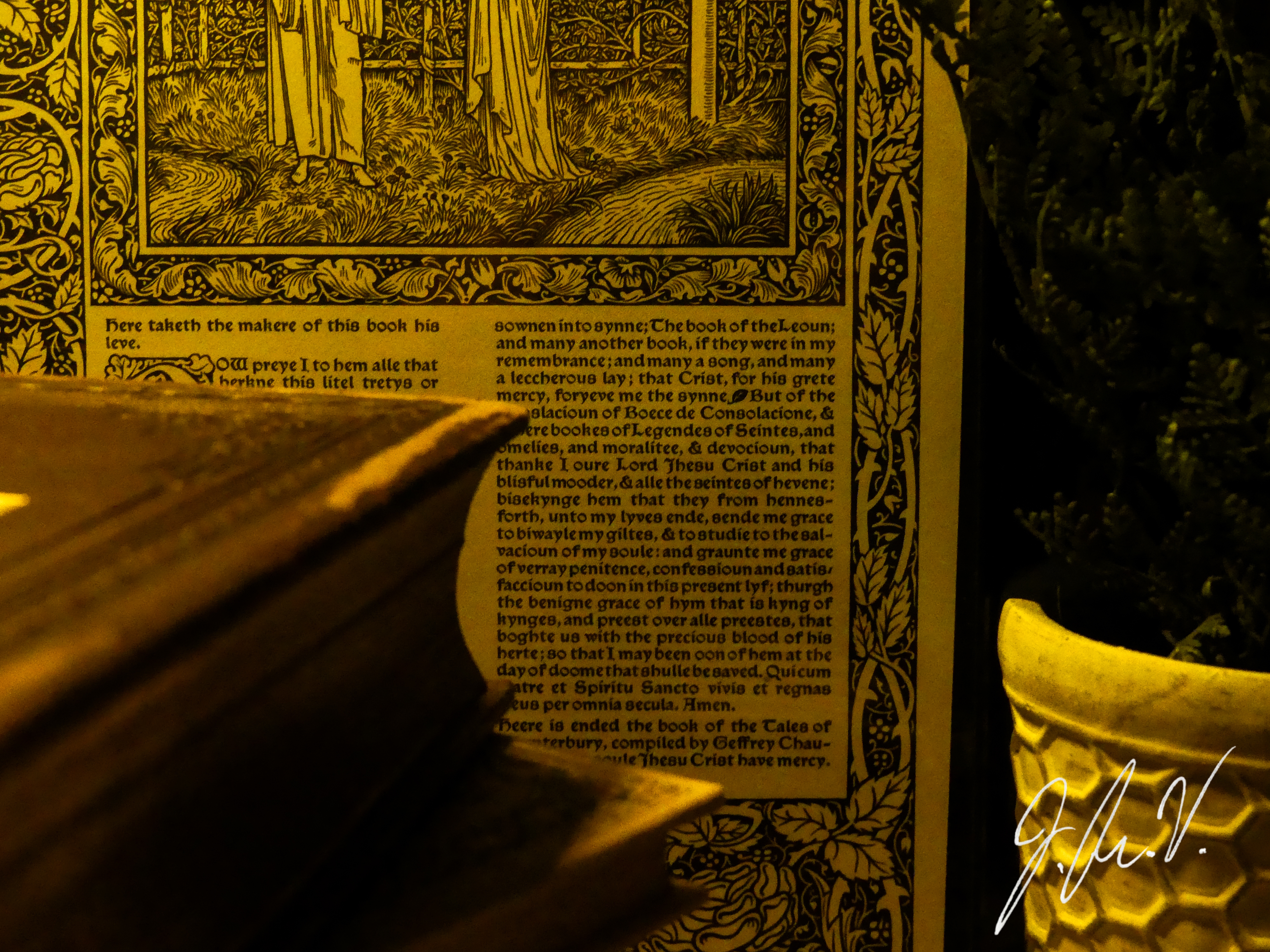 Photograph of a poetry book before a Page from the Canterbury Tales