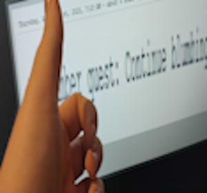 a photo of the world's worst thumbs up, with the post "blumber quest: continue blumbing" in the background. the image is of very low quality, and is squashed horizontally"