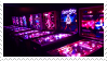 Pinball machines in the dark, magenta filter.