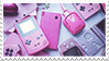 A bunch of pink handheld game consoles.