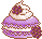A purple macaron topped with whipped cream and blackberries.