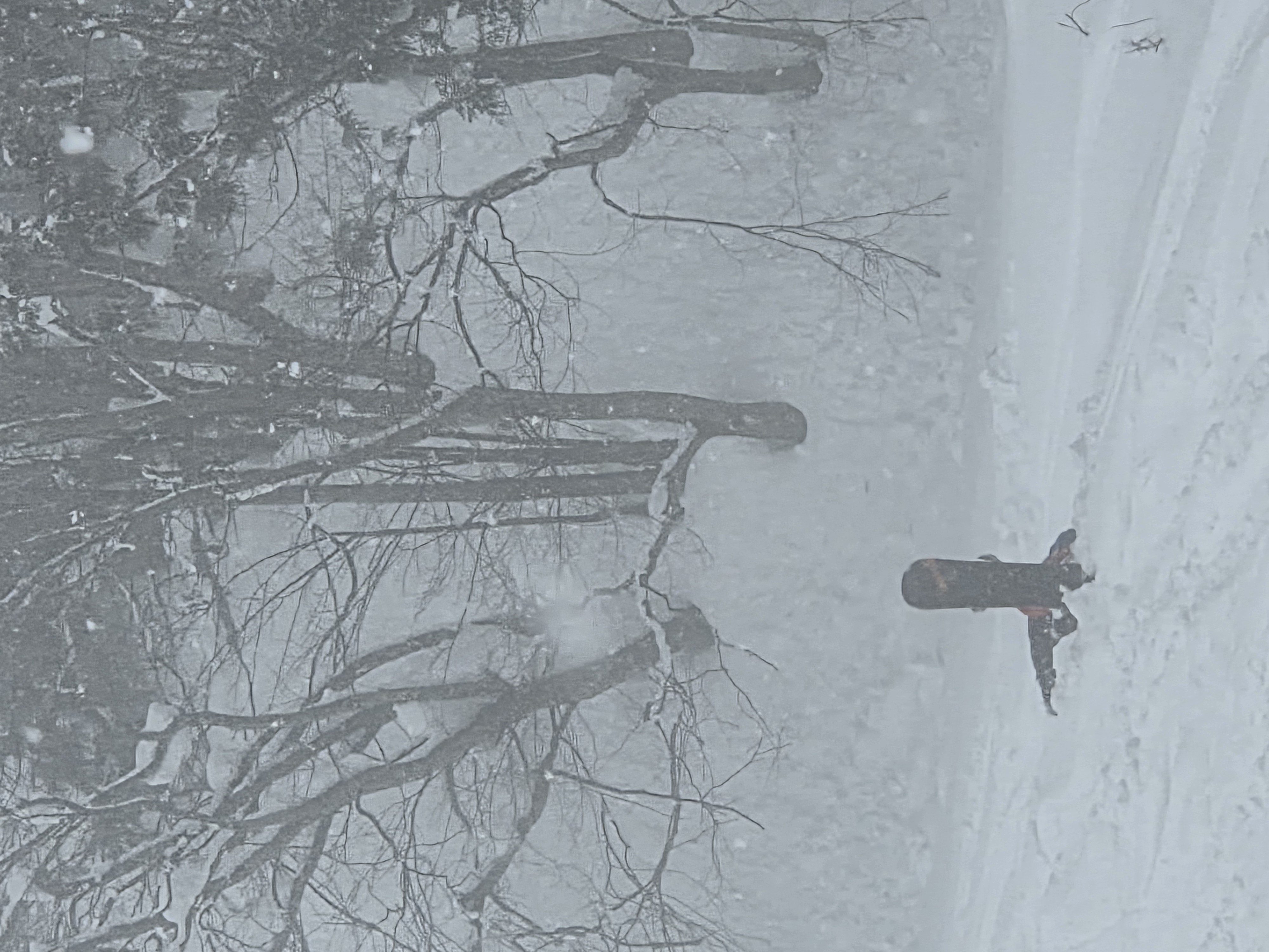Snowboarder struggling to get up in the distance
