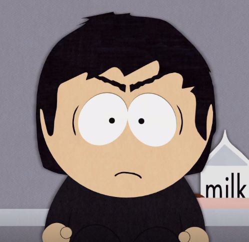 a young boy with long black hair and large angry eyebrows