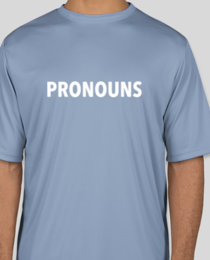 a white man wearing a blue shirt that says PRONOUNS