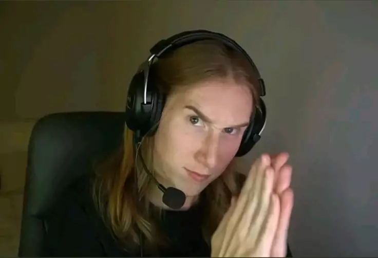 Reaction Meme of Streamer Katie B smirking into camera, menacingly.
