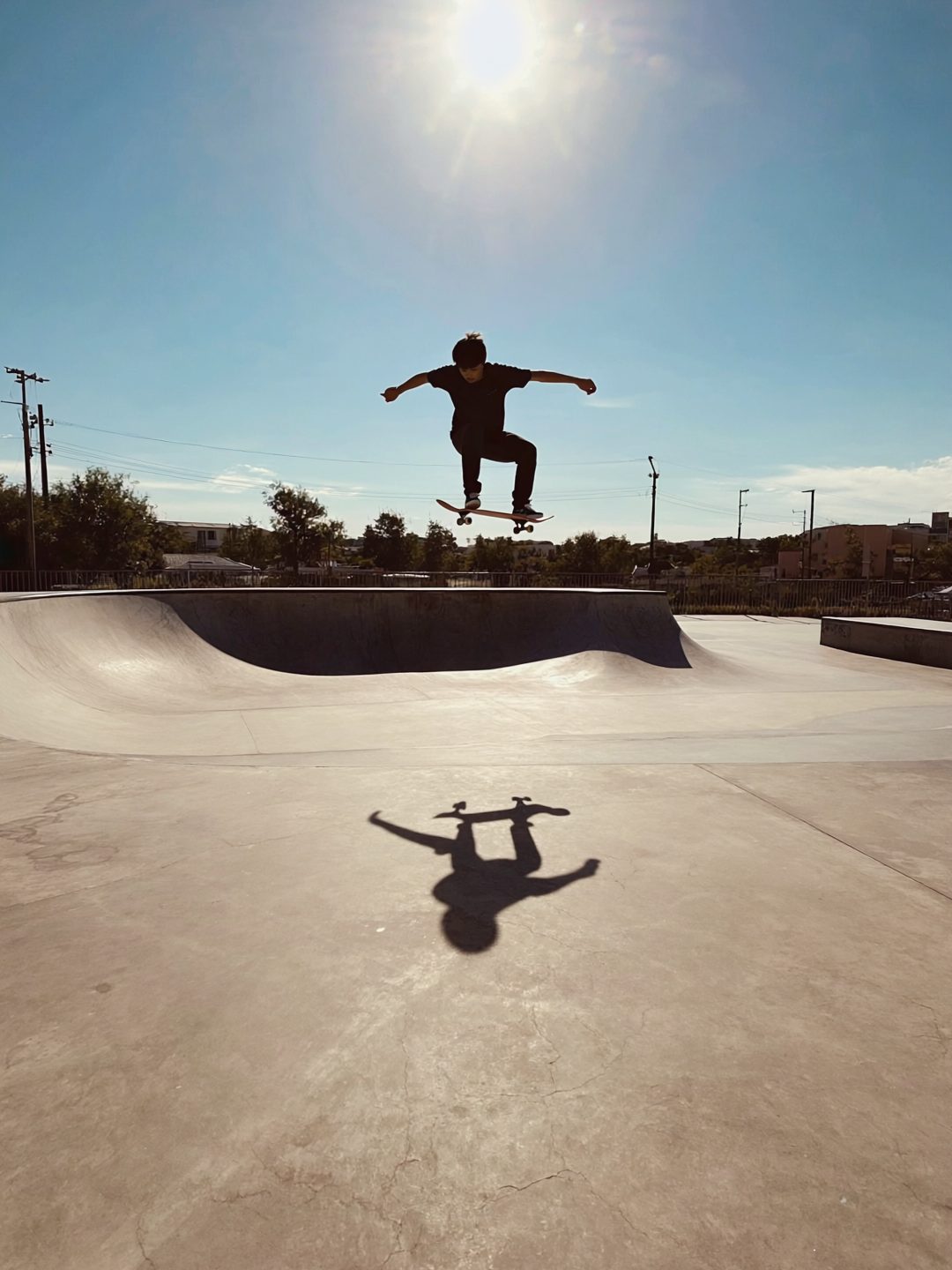 Skateboarder Airborne in Sunny Park
