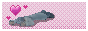 Ienzo as a child laying on the ground, bobbing up and down with pixel art hearts on a pink backround.