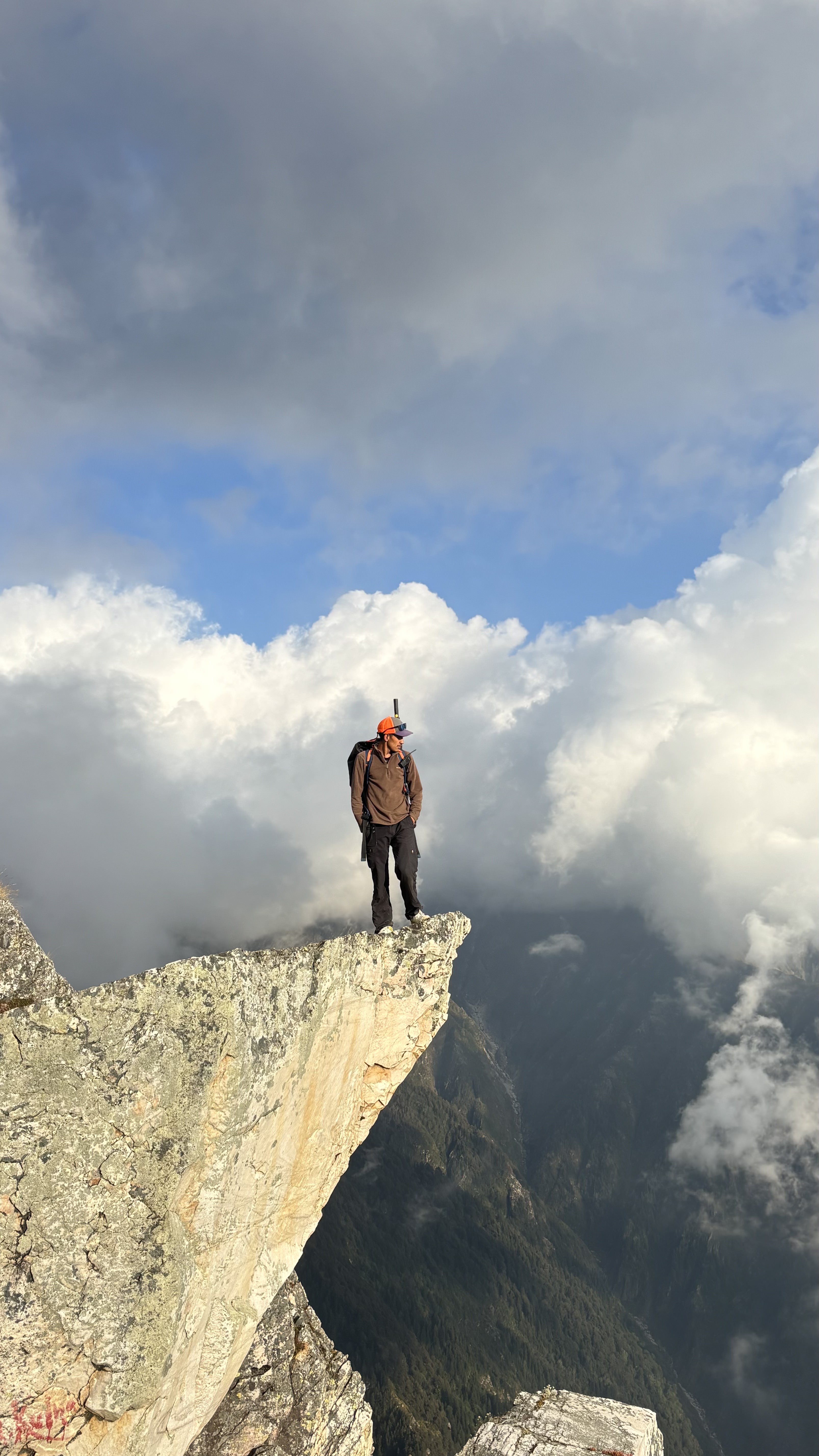 Our head guide on a high mountain ridge above the clouds
