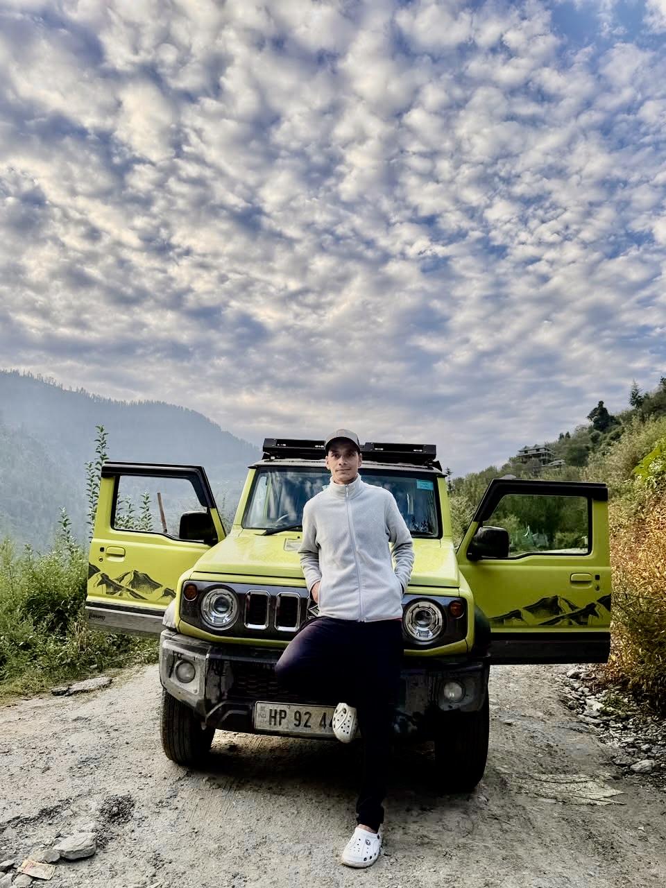 Our head guide beside an expedition vehicle in the mountains
