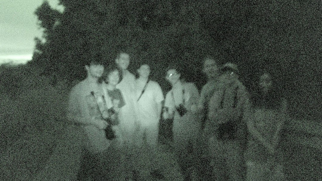 really bad photo of me and my friends after sunset on a boardwalk on a Big Day